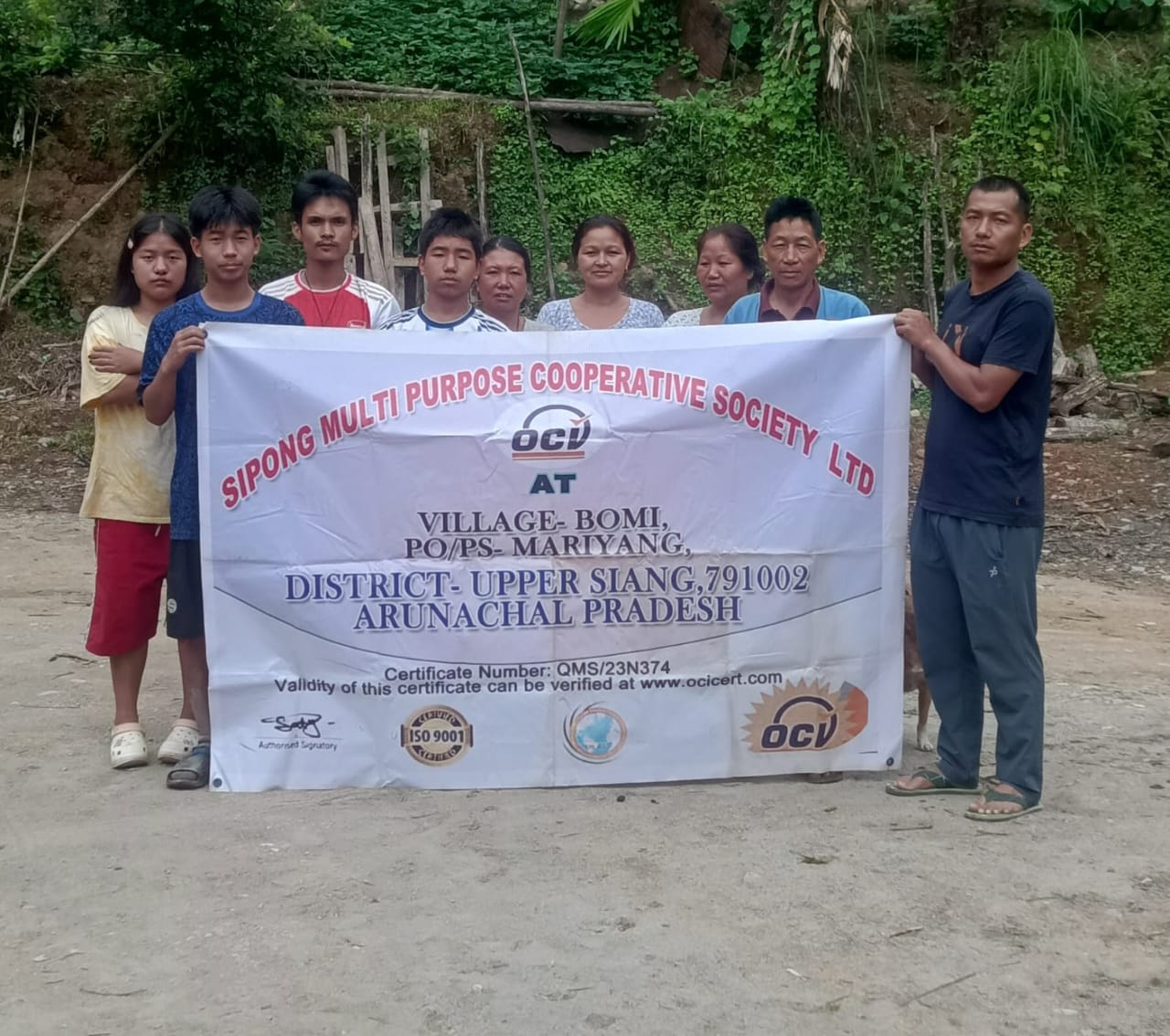 SIPONG members standing with the society banner at Bomi Village